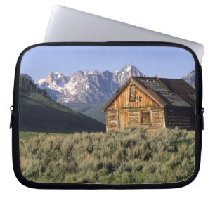 A log cabin and the Sawtooth Mountains in Laptop Sleeve