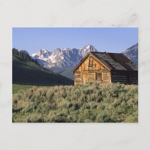 A log cabin and the Sawtooth Mountains in Postcard