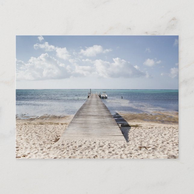 A long dock with a boat at the end stretches out postcard (Front)