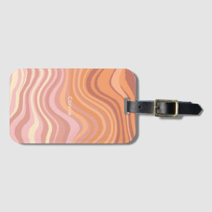 A luggage tag with sunset colors in waves.