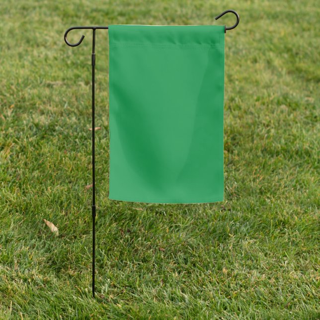 A lush green backdrop with a clean white square po garden flag (In SItu)