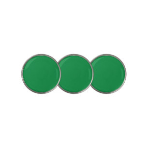 A lush green backdrop with a clean white square po golf ball marker