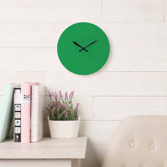 A lush green backdrop with a clean white square po large clock (Reading Room)