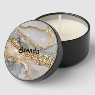 A luxurious gold and white marble background mini candle favors