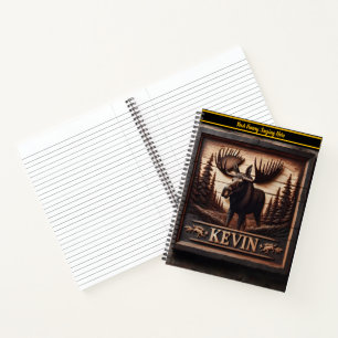 A majestic moose carved into a wooden sign notebook