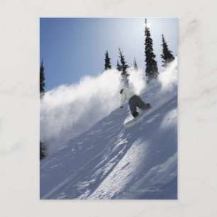A male snowboarder ripping powder in Idaho. Postcard