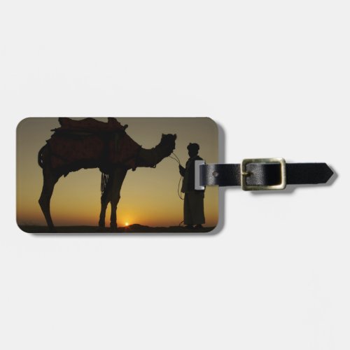 a man and his camel Silhouetted at sunset on the Luggage Tag