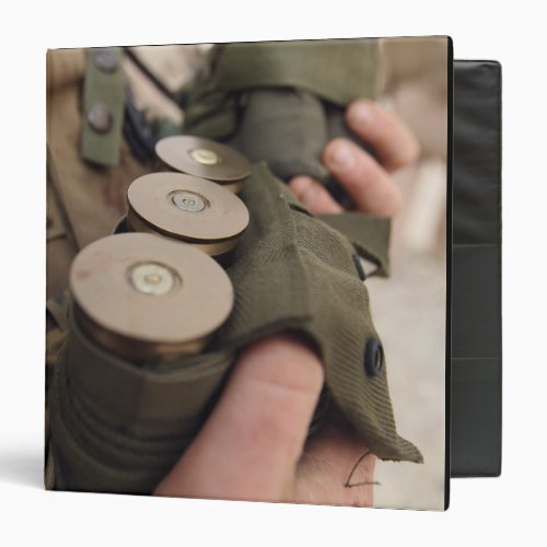 A Marine cradles handfuls of 40 mm grenades Binder
