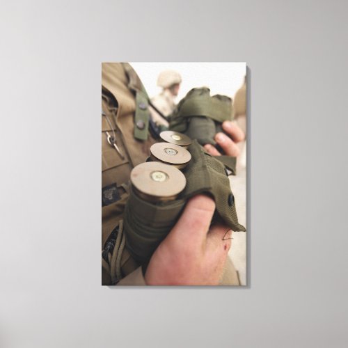 A Marine cradles handfuls of 40 mm grenades Canvas Print