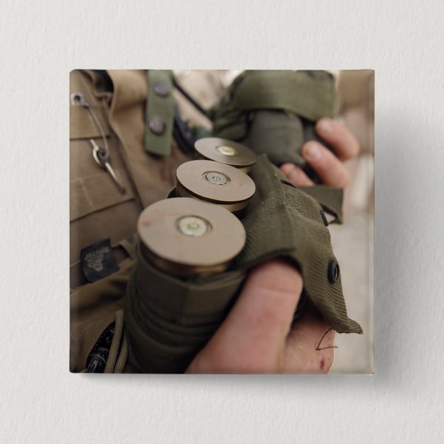 A Marine cradles handfuls of 40 mm grenades Pinback Button (Front)