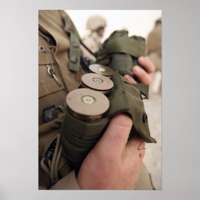 A Marine cradles handfuls of 40 mm grenades Poster (Front)