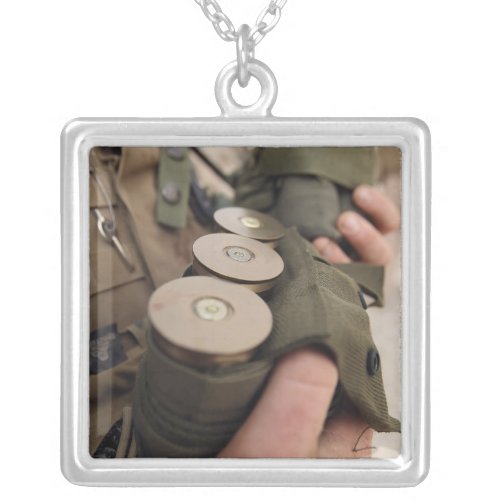 A Marine cradles handfuls of 40 mm grenades Silver Plated Necklace