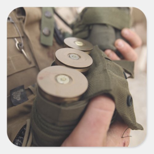 A Marine cradles handfuls of 40 mm grenades Square Sticker