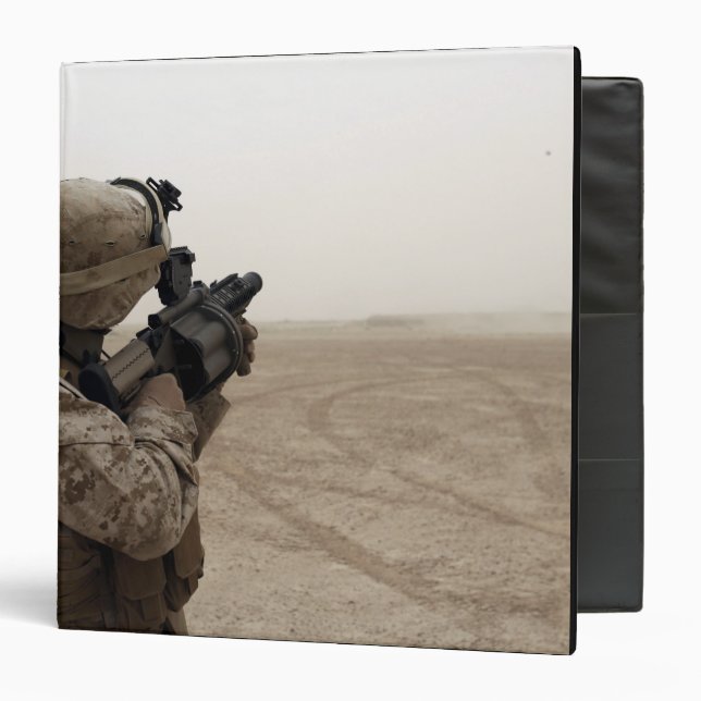 A Marine fires the M-32 3 Ring Binder (Front/Inside)