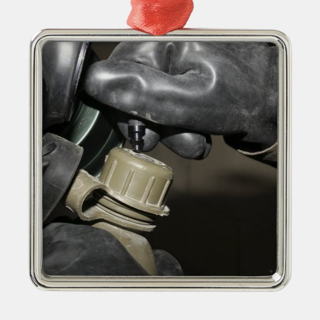 A Marine inserts a drinking tube into his cante Metal Ornament (Front)