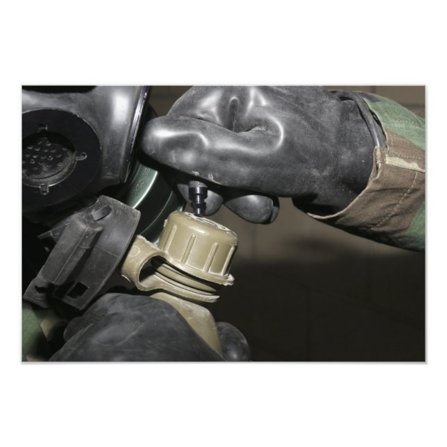 A Marine inserts a drinking tube into his cante Photo Print (Front)