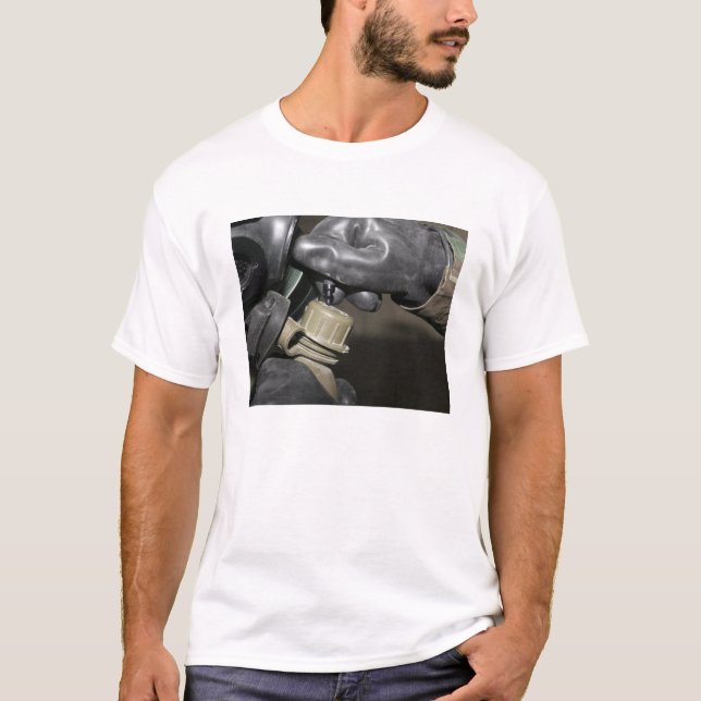 A Marine inserts a drinking tube into his cante T-Shirt (Front)