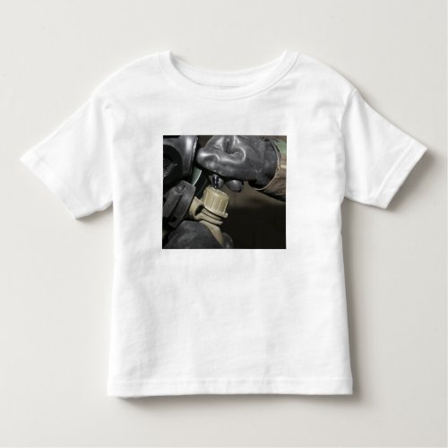 A Marine inserts a drinking tube into his cante Toddler T_shirt