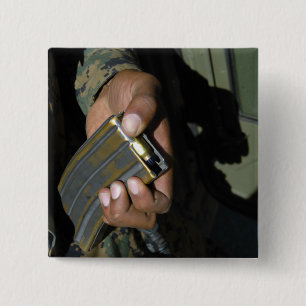 A Marine loads blank ammunition rounds Pinback Button