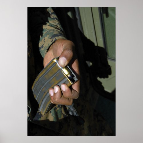 A Marine loads blank ammunition rounds Poster
