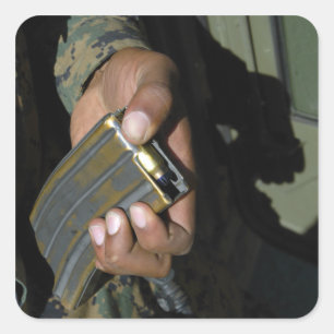 A Marine loads blank ammunition rounds Square Sticker