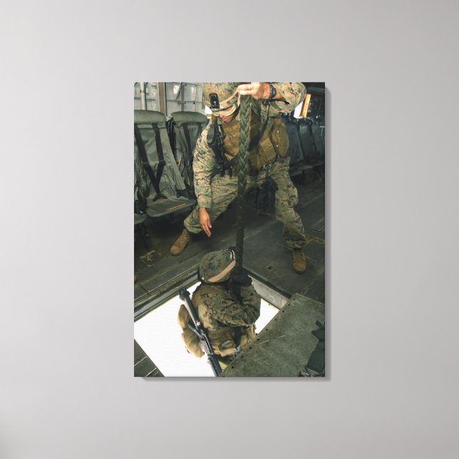 A Marine sends a fellow Marine down the hell ho Canvas Print (Front)