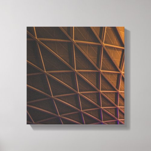 A meshwork of steel beams on an illuminated facade canvas print