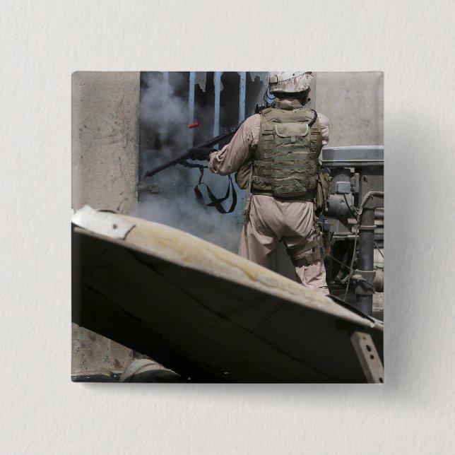 A military policeman uses a breaching round button (Front)