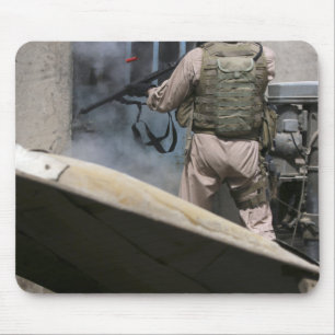 A military policeman uses a breaching round mouse pad