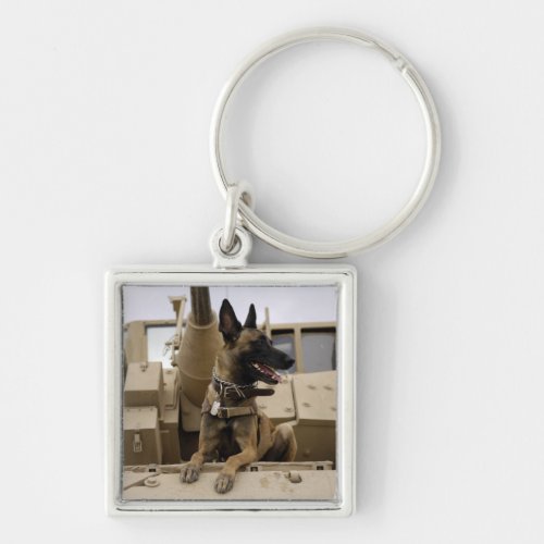 A military working dog sits on a M2A3 Keychain