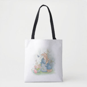 A mother rabbit with a baby rabbit in a clearing w tote bag