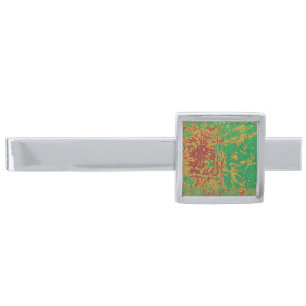 a painting of a green field with an orange border silver finish tie bar