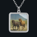 A Pair of Brown Icelandic Ponies Silver Plated Necklace<br><div class="desc">A totally cute and adorable photo capture of 2 icelandic ponies trotting down a dirt road. One is a bay and the other is chestnut colored. Their gorgeous manes blowing in the wind. A beautiful mountain landscape can be seen in the background and adds a sense of wonder to this...</div>