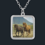 A Pair of Brown Icelandic Ponies Silver Plated Necklace<br><div class="desc">A totally cute and adorable photo capture of 2 icelandic ponies trotting down a dirt road. One is a bay and the other is chestnut colored. Their gorgeous manes blowing in the wind. A beautiful mountain landscape can be seen in the background and adds a sense of wonder to this...</div>