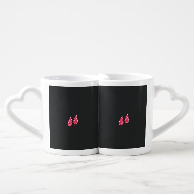 a pair of red leaves on a black background coffee mug set (Front Nesting)