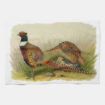 A pair of Ring necked pheasants in a grassy field Kitchen Towel