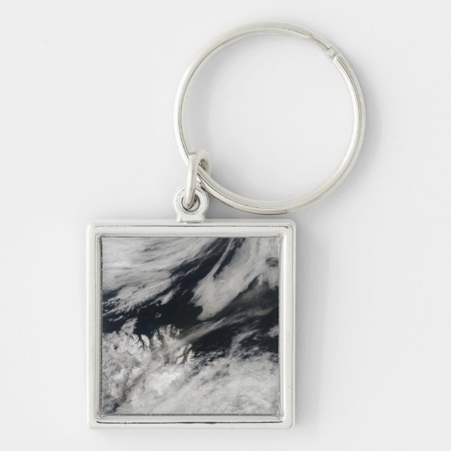 A pale gray ash plume blows from the summit keychain (Front)