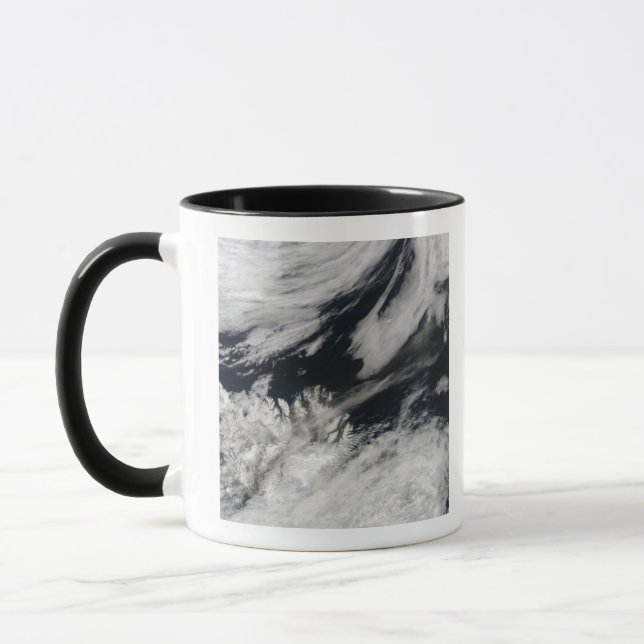 A pale gray ash plume blows from the summit mug (Left)