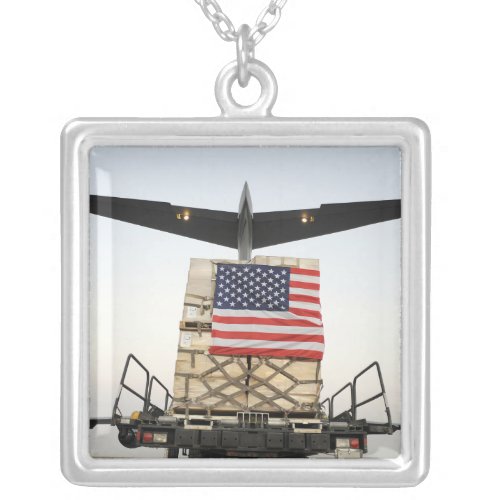 A pallet containing humanitarian relief supplie silver plated necklace