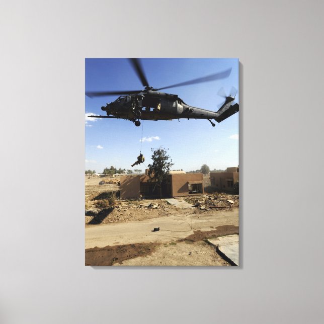 A pararescueman rappels from an HH-60 2 Canvas Print (Front)