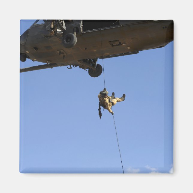 A pararescueman rappels from an HH-60 Magnet (Front)