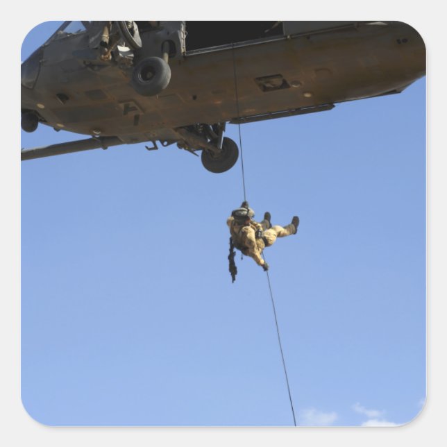 A pararescueman rappels from an HH-60 Square Sticker (Front)