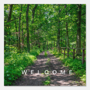 A path in the green forest sign