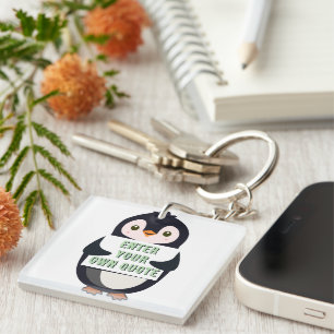 A penguin holding a sign with customizable text th keychain
