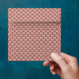a pink and white background with a pattern envelope