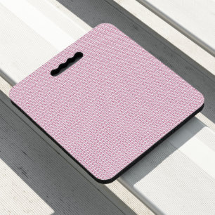 a pink and white background with wavy lines seat cushion