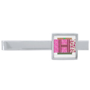 a pink and white wallpaper with a cross on it silver finish tie bar