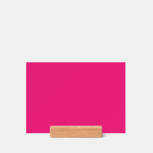 a pink background with a black border holder