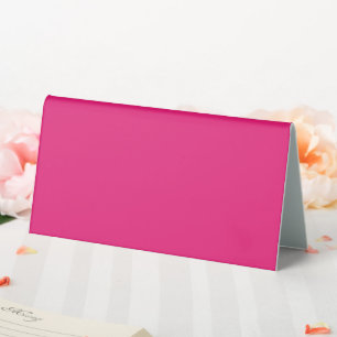a pink background with a black border table tent