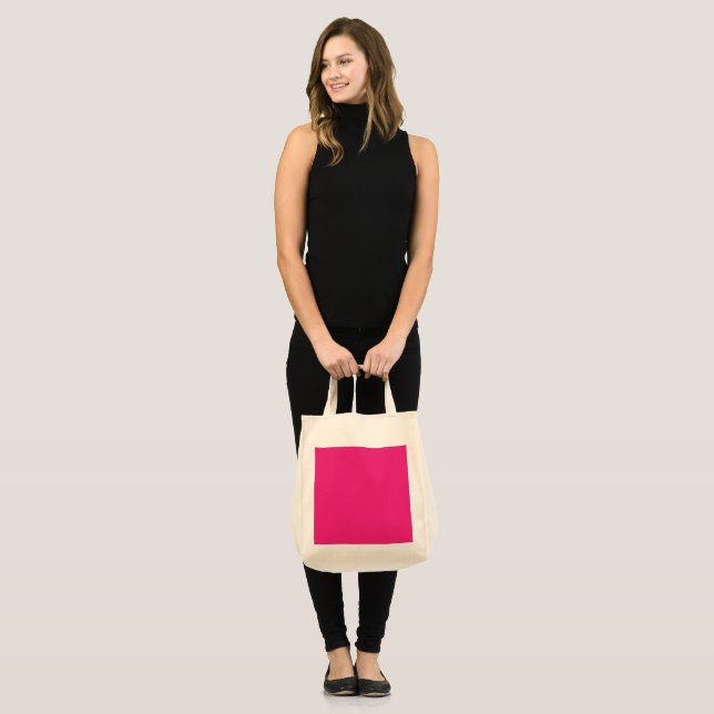 a pink background with a black border tote bag (Front (Model))